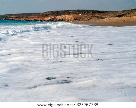 Foam And Waves In The Sea On A Sunny Day. Foam And Waves In The Sea. Powerful Waves Crushing For Bac