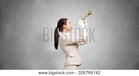 Business Woman Playing Trumpet Brass. Young Lady In White Business Suit And Gloves Posing With Music