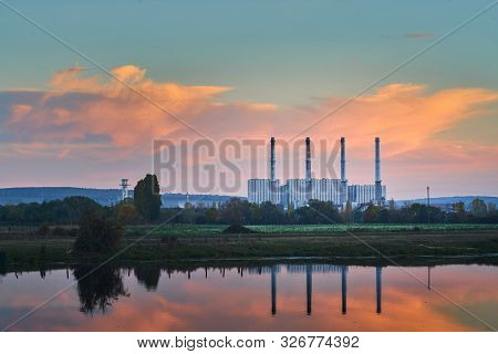 Coal Power Plant Stopped And Undergoing Reconversion Shot A Blue Hour With Reflection In A Nearby La