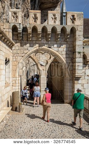 Rocamadour, France - September 3, 2018: Stone Walls Of Historic Basilica Of St-sauveur Blend Into Th