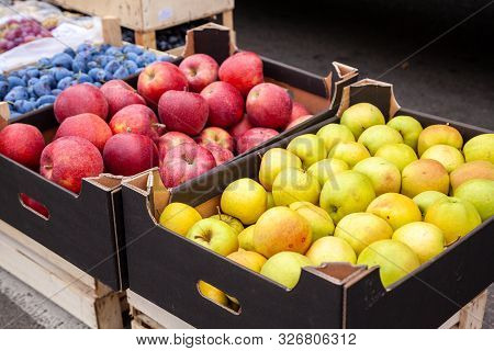 Crates Of Apples At A Farmers Market. Cardboard Boxes With Various Kinds Of Apples In The Local Agri