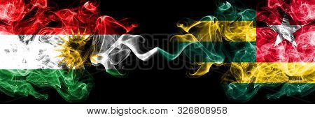 Kurdistan Vs Togo, Togolese Smoke Flags Placed Side By Side. Thick Colored Silky Smoke Flags Of Kurd