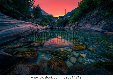 Colorful Sunset Above The Double Arch Stone Bridge At Ponte Dei Salti In Lavertezzo, Canton Tessin, 