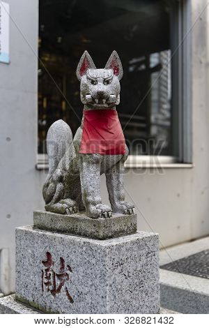 Tokyo, Japan - October 31st, 2018: A Statue Of Kitsune, The Fox, Holding A Message In Its Mouth, In 