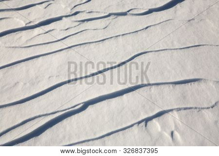 Narrow Elongated Ridges Of Snow Across The Wind. Landform Background.
