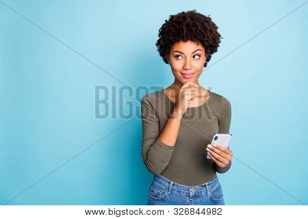 Photo Of Cunning Smirking Puzzled Interested Dark Skinned Youngster Touching Her Chin In Thought Of 