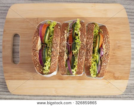 Delicious Healthy Hummus Sandwich With Alfalfa Onions Tomatoes Cucumber And Lettuce In Multi Grain B