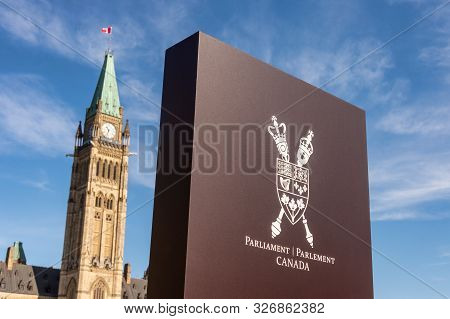 Sign Showing Canada Coat Of Arms And Canadian Parliament Peace Tower In Ottawa