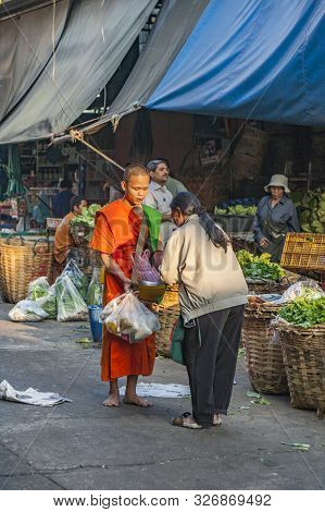 Bangkok, Thailand - Dec 23, 2009: People Donate Food To The Monk In Bangkok, Thailand. Mendicant Mon