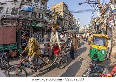 New Delhi, India - Nov 17, 2011: Man Carries  Cargo And People With His Rickshaw  In Old Delhi, Chaw