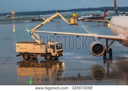 Hamburg, Germany - December 6: Deicing Of The Lufthansa Plane Before Take Off On December 6, 2011 In
