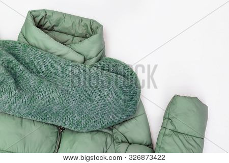 Autumn Comfortable Clothes. Trendy Warm Down Jacket Mint Colored, Wide Knitted Scarf On White Backgr