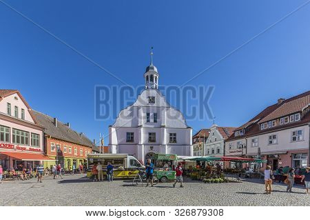 Wolgast, Germany - Aug 13, 2015: People Enjoy Gothic St Petri Church In Wolgast Under Blue Sky With 