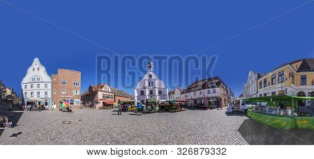 Wolgast, Germany - Aug 13, 2015: People Enjoy Gothic St Petri Church In Wolgast Under Blue Sky With 