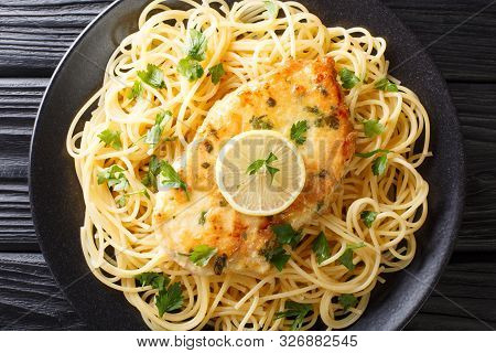 Cooked Chicken Francaise With Spaghetti In Lemon Wine Gravy Close-up On A Plate. Horizontal Top View