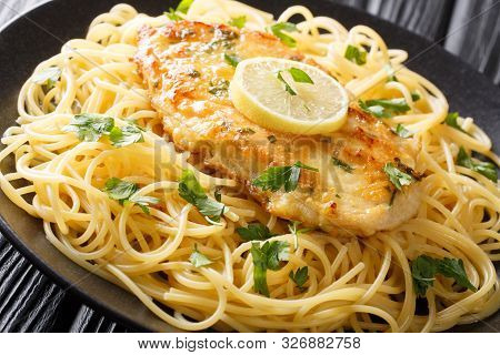 Cooked Chicken Francaise With Spaghetti In Lemon Wine Gravy Close-up On A Plate. Horizontal