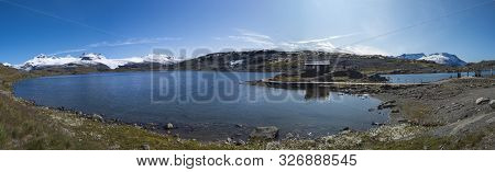 Wide Panoramatic View From Sognefjellshytta With Blue Glacier Fantesteinsvatnet Lake Along National 