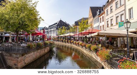 Saarburg, Germany - Aug 28, 2018: City Center Of Saarburg With Creek And Restaurants At The Promenad