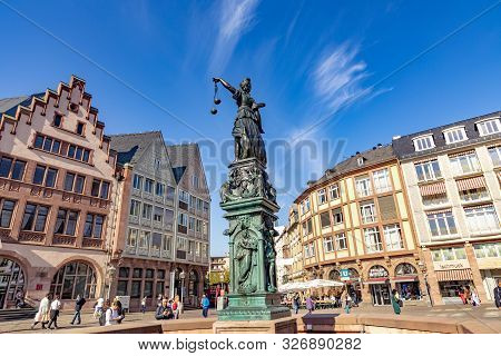 Frankfurt, Germany - Oct 15, 2018: People Visit The Roemer Place  With Fountain Of Lady Justice In F