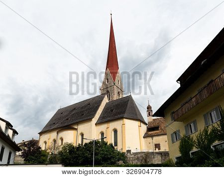 The Church Of Schlanders (south Tyrol, Italy) On A Cloudy Day In Summer