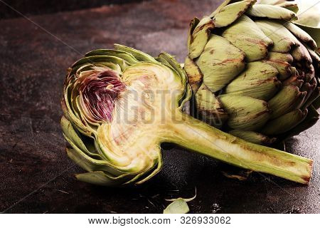 Artichokes On Rustic Dark Background. Fresh Organic Artichoke Flower.