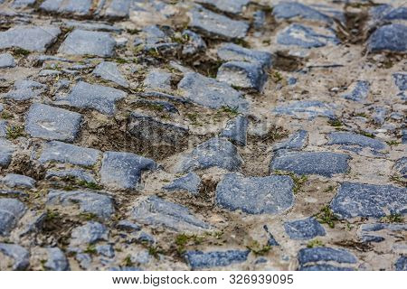 Detail Of A Cobbelstone Road Located In The North Of France Near Lille. On Such Roads Every Year Is 