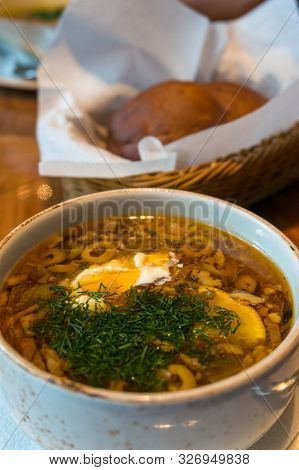 Close Up Of Borscht Or Borsht Soup In A Rustic Bowl Garnished With Sour Cream And Dill