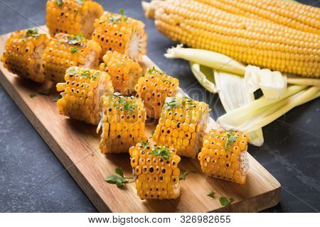 Sweet corn slices grilled and spiced as healthy party food alternative
