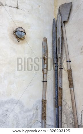 Oars From The Arab Boat Stand Near The Wall In The Dock.