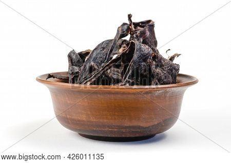 Dried Dog Treats In A Brown Clay Bowl On A White Background. Thin Slices Of Dehydrated Beef Heart. T