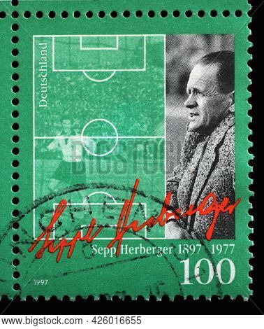 ZAGREB, CROATIA - AUGUST 29, 2014: A stamp printed in Germany showing National Football Team Coach Sepp Herberger with his signature and a soccer field, circa 1997