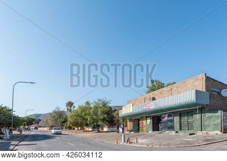 De Doorns, South Africa - April 20, 2021: A Street Scene, With Businesses, Peoiple And A Vehicle, In