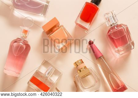 Group Of Perfume Bottles On Orange Background