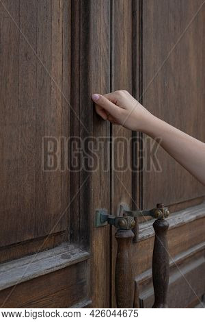 A Woman's Hand Knocking On A Closed Wooden Door, Surprise Visit, Closed, Is Anyone At Home?