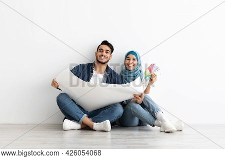 Young Arab Couple Working On New Home Interior