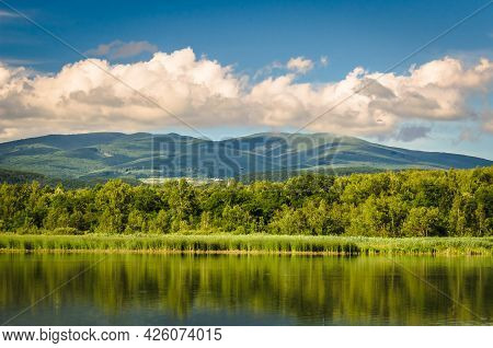 Summer Landscape Of A Fish Lake On A Background Of Mountains