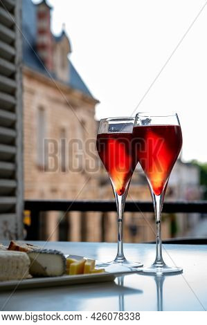 Drinking Of Kir Royal,  French Aperitif Cocktail Made  From Creme De Cassis Topped With Champagne, T