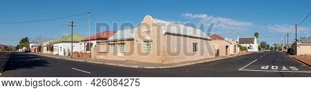 Touws River, South Africa - April 20, 2021: A Panoramic Street Scene, With Buildings, People And Veh