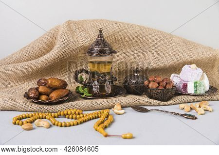 Tea Glass With Eastern Sweets Beads. High Quality Beautiful Photo Concept