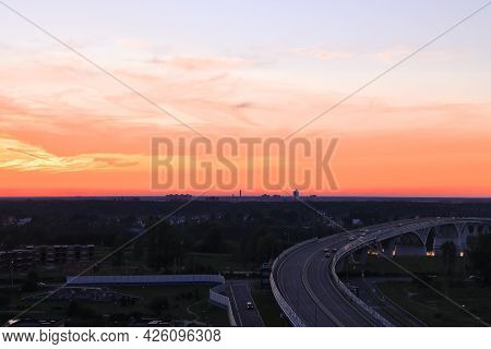 Flaming Sunset Against The Background Of The Bridge Over The Volga, Bright Background, Dubna, Moscow