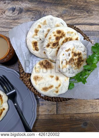 A Close Up Of A Basket Of Baati Roti For Breakfast.