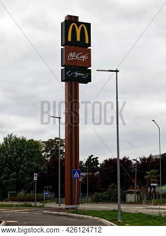 Casalecchio - Bologna, Italy - May 8, 2021: Mcdonald\'s, Mccafè, And Mcdrive Signs On A Pole. Mcdona
