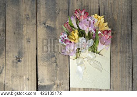 Multicolored Flowers In Envelope With Copy Space. Multicolored Alstroemerias, Pink, Yellow, Purple,
