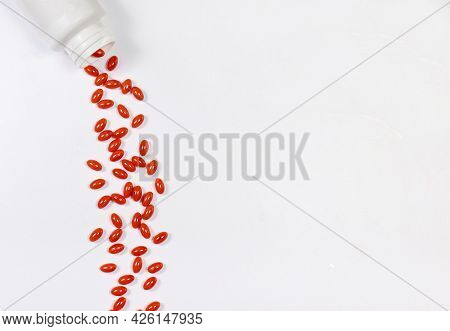 Orange Capsules Of Lutein On A White Background With Place For Text. Supplements And Herbal Medicine