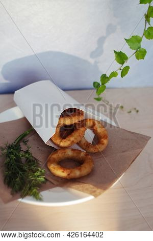 Close-up Of Onion Rings In Batter. Fried Vegetables At A Fast Food Restaurant. Vegetarian Cuisine In