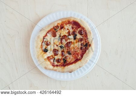 A Close-up Of A Mini Pizza In A Disposable Dish. Top View Of Takeaway Food In Fast Food Cafe. The Ph
