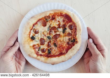 A Close-up Of A Mini Pizza In A Disposable Dish. Top View Of Takeaway Food In Fast Food Cafe. The Ph