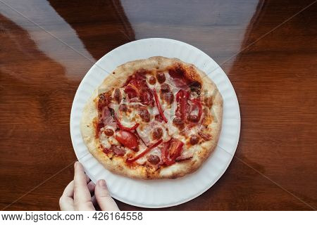 A Close-up Of A Mini Pizza In A Disposable Dish. Top View Of Takeaway Food In Fast Food Cafe. The Ph