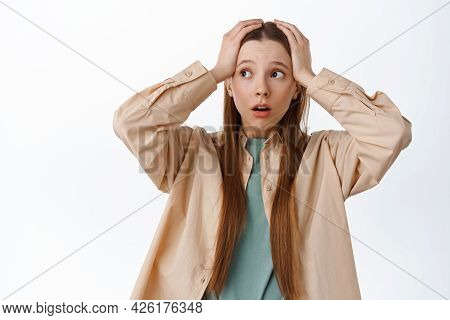 Anxious Young Woman Holding Hands On Head, Panicking And Looking Aside At Logo, Having Proble, Stand