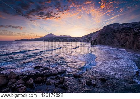 Fyriplaka beach and waves of Aegean sea on sunset, Milos island, Cyclades, Greece